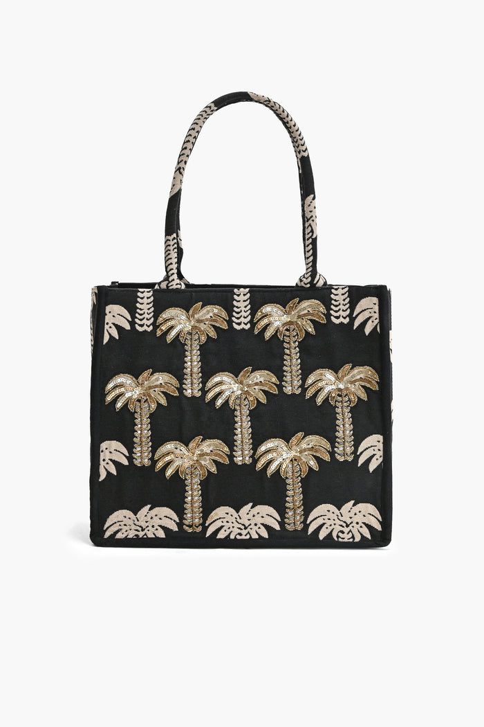 Black tote bag with gold palm tree patterns on a white background